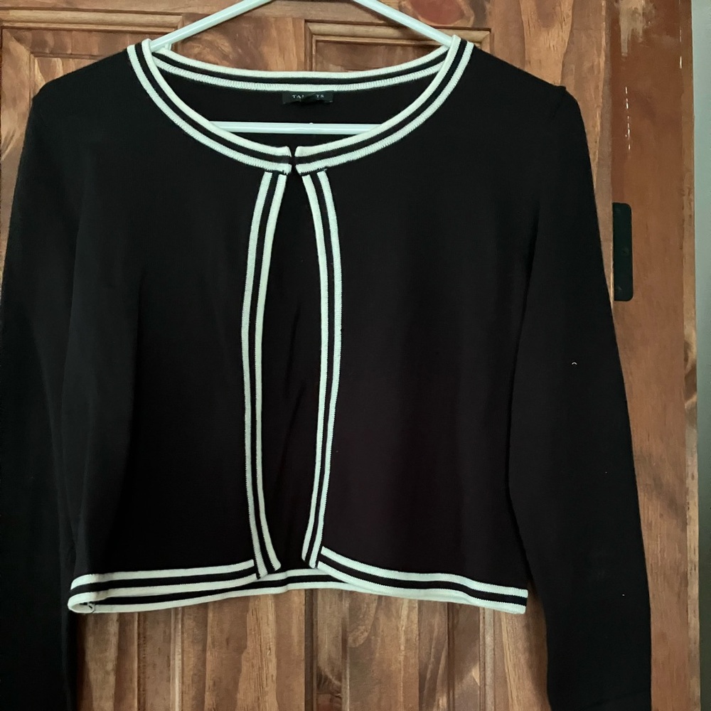 Black/off white trim shrug sweater.  Looks great over black and white dress.